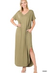 Tall woman with ponytail wearing Khaki colored Maxi dress with slit down side from knee to ankles