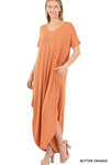 Tall woman with ponytail wearing Butter Orange colored Maxi dress with slit down side from knee to ankles