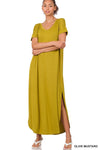 Tall woman with ponytail wearing Olive Mustard Maxi dress with slit  down side from knee to ankles